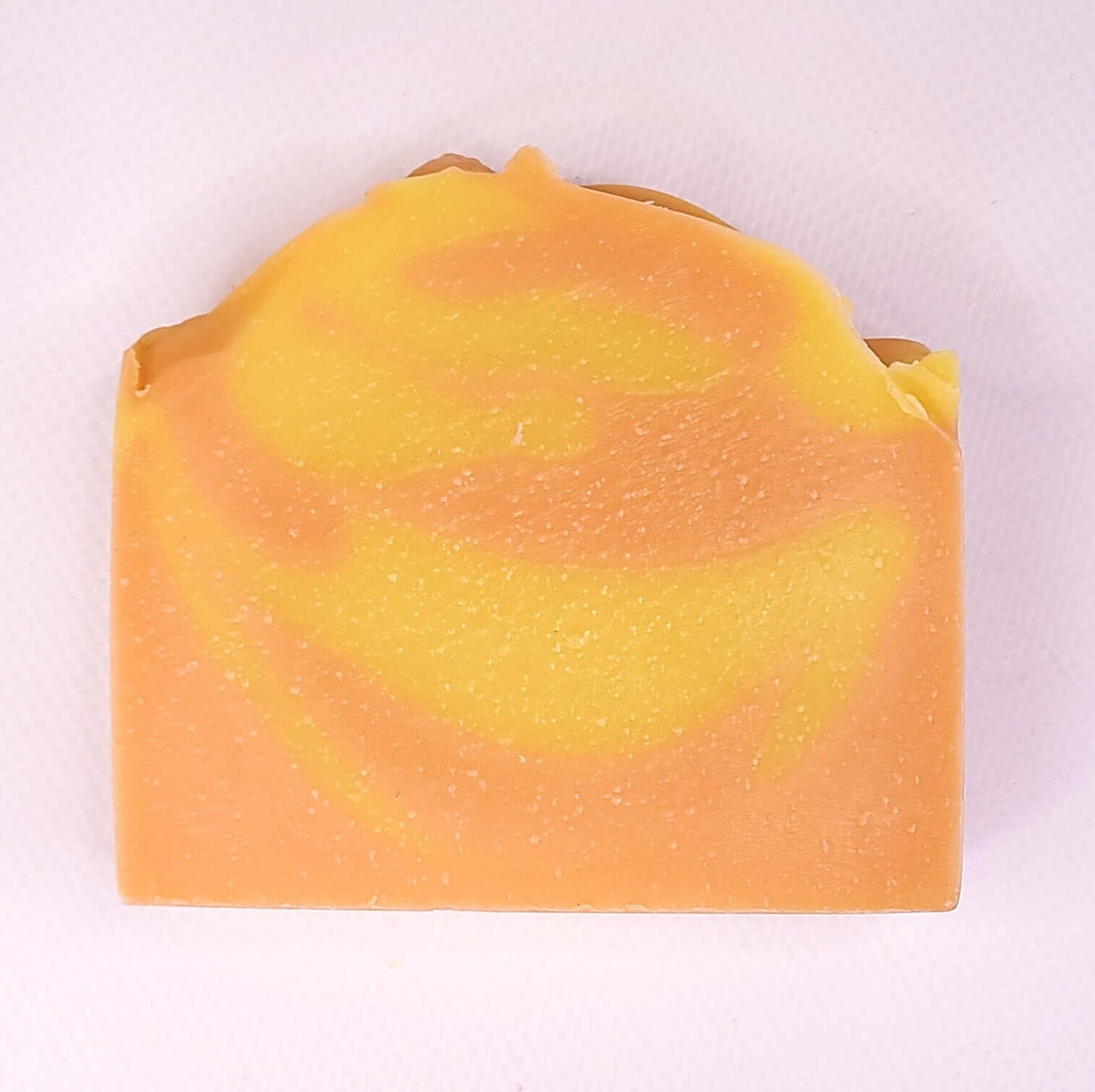 Orange Spice soap bar with citrus and spice swirls, invigorating scent, natural ingredients, energizing for fresh and soft skin.