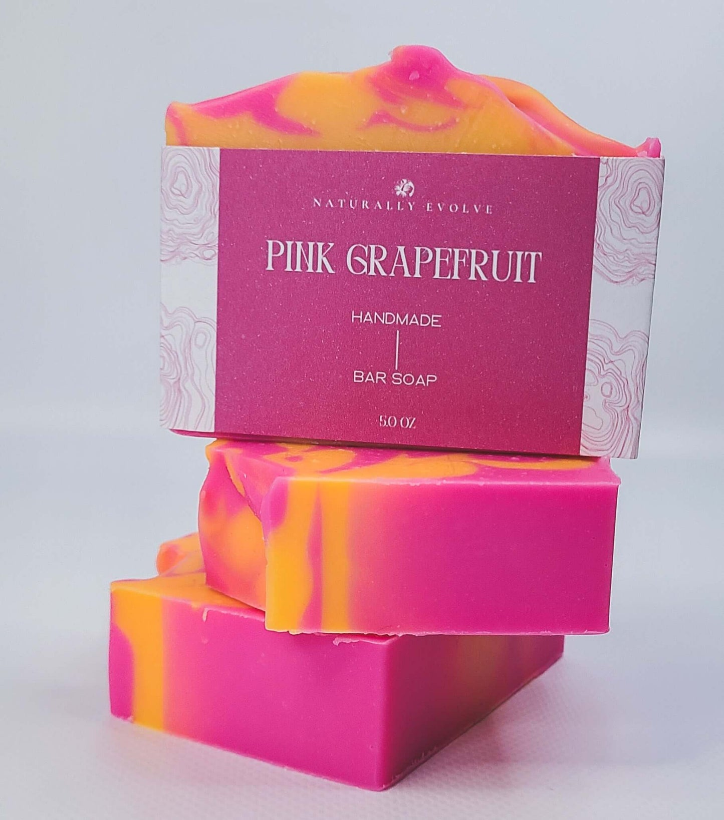 Pink Grapefruit handmade bar soap with vibrant pink and orange swirls, perfect for a refreshing and uplifting morning cleanse.