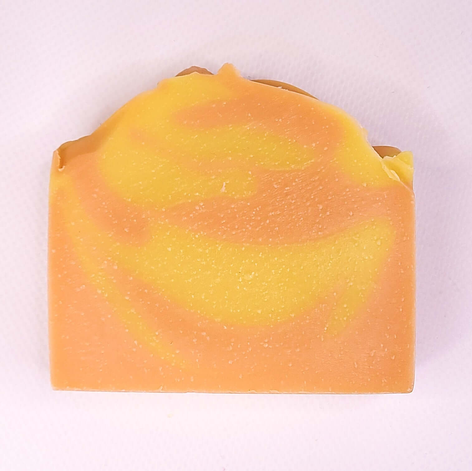 Orange Spice soap bar with citrus and spice swirls, invigorating scent, natural ingredients, energizing for fresh and soft skin.